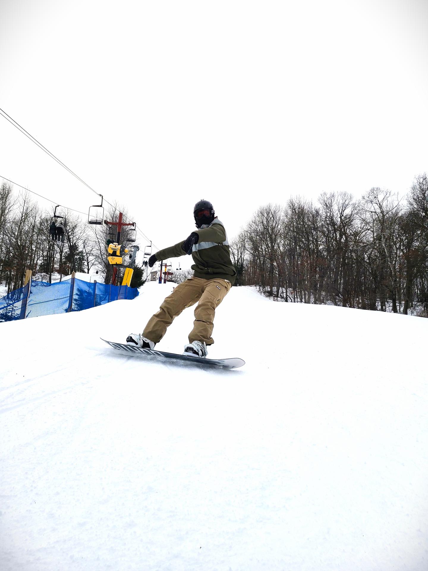 snowboarder coming out of turn on hill