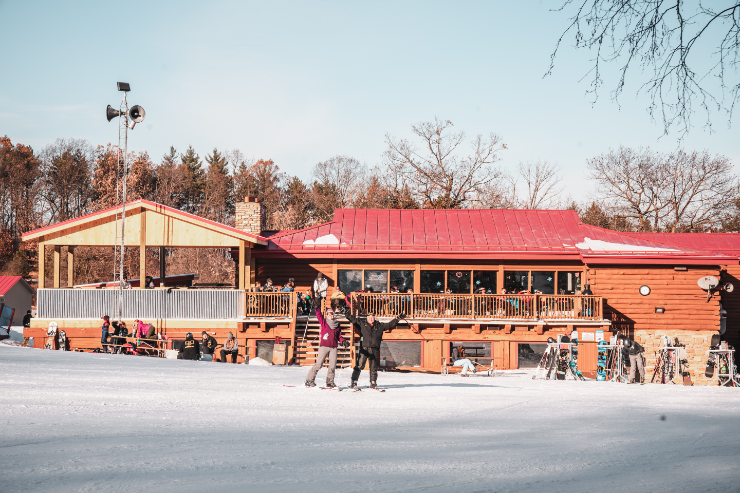 two people celebrating in front of ski lodge