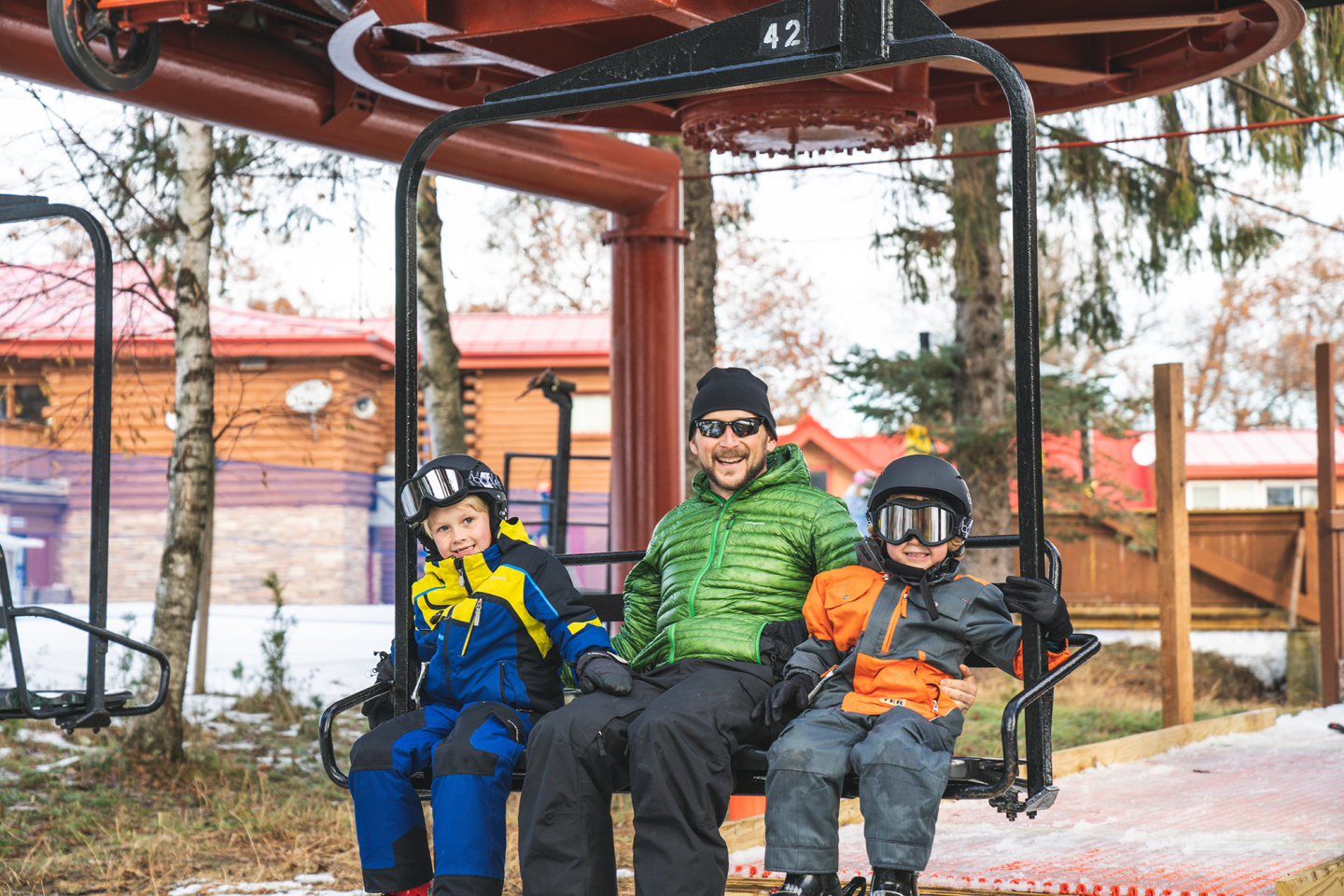 dad with kids on chairlift 