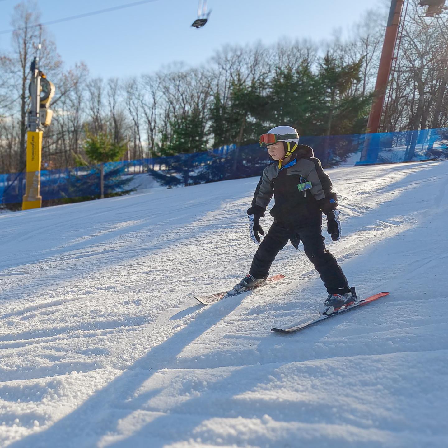 kid on skis going down hill