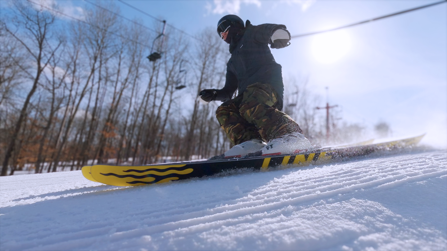 Skier going down hill with helmet on