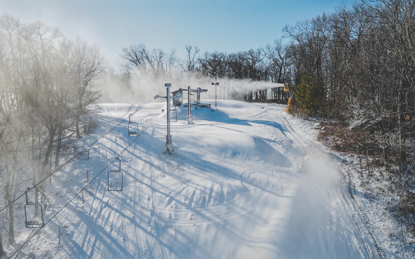 drone shot of chair lift in winter scenery
